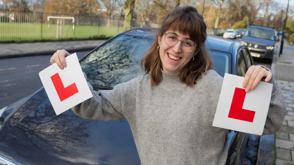 Learner holding L plates